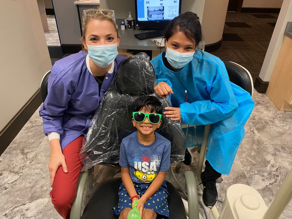pediatric dentist and orthodontist in Viridian with a patient
